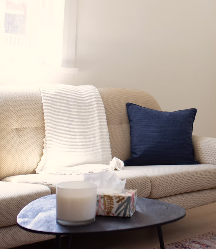 Therapy office couch with throw blanket and pillows